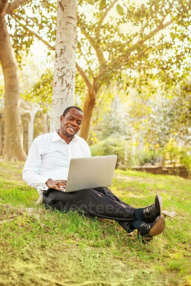Afro man working in the park photo