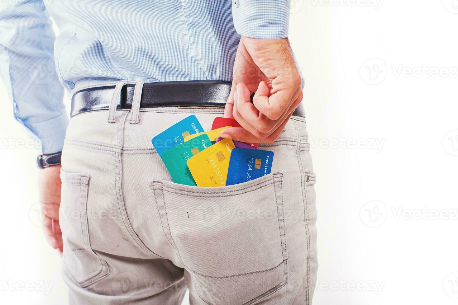 Faceless photo of a man taking out many credit cards out of his pocket, isolated on white background