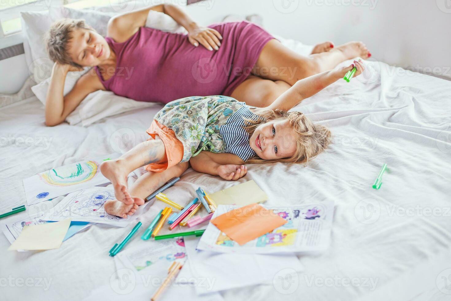 Mother playing and drawing with her baby daughter photo