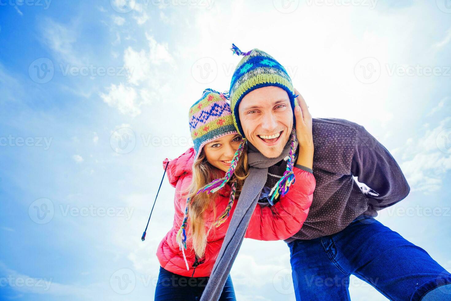 Couple hugging in winter day dressed in woolen hats photo