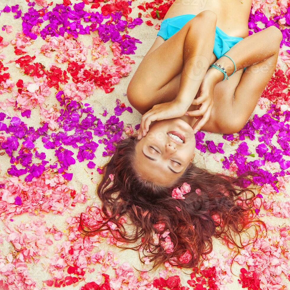 woman relaxing on a flower petals photo