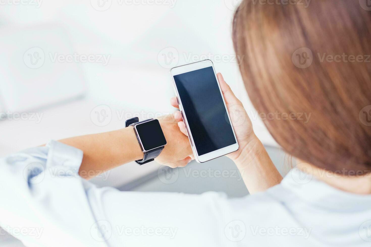 woman using smart phone and smart watch. App design template. Focus on phone photo