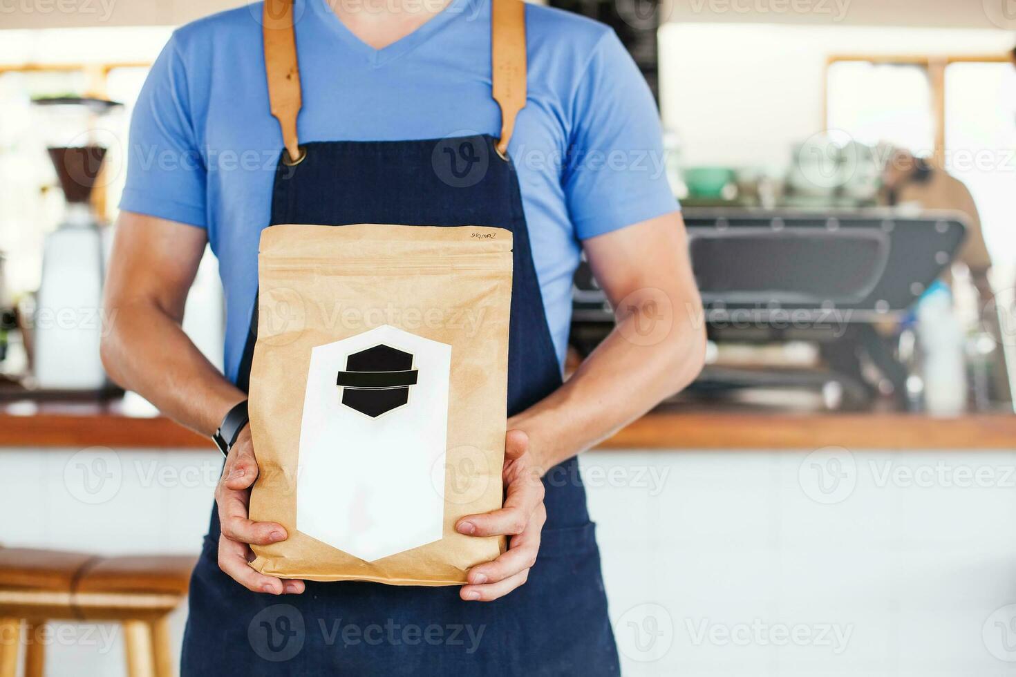 Package design template mockup. Man holding blank coffee package photo