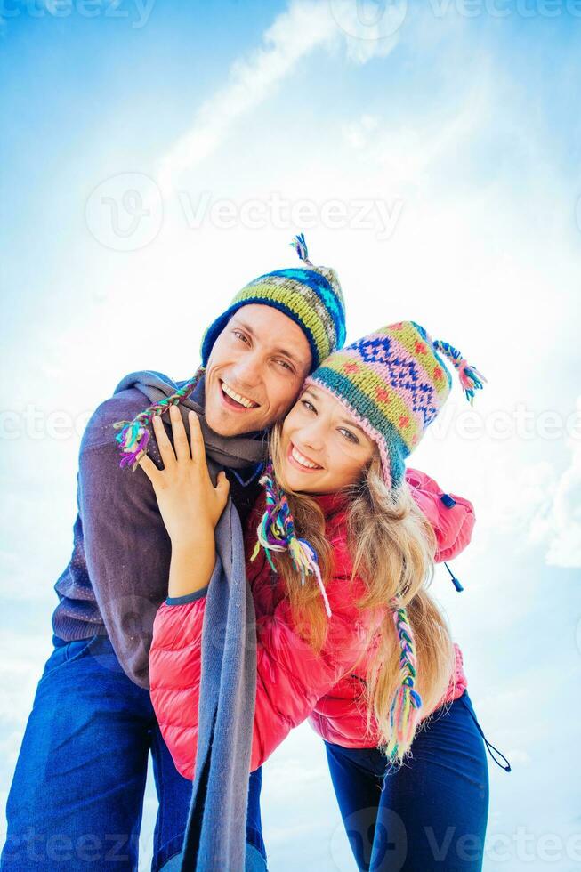 Couple hugging in winter day dressed in woolen hats photo