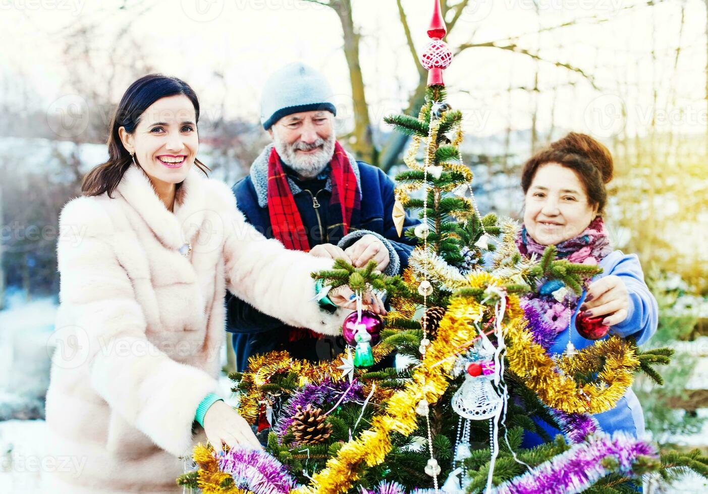Family setting up a Christmas tree photo