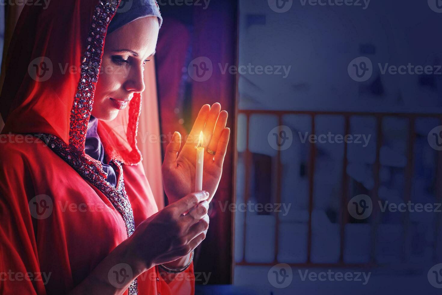 muslim woman holding candle in a ramadan night photo