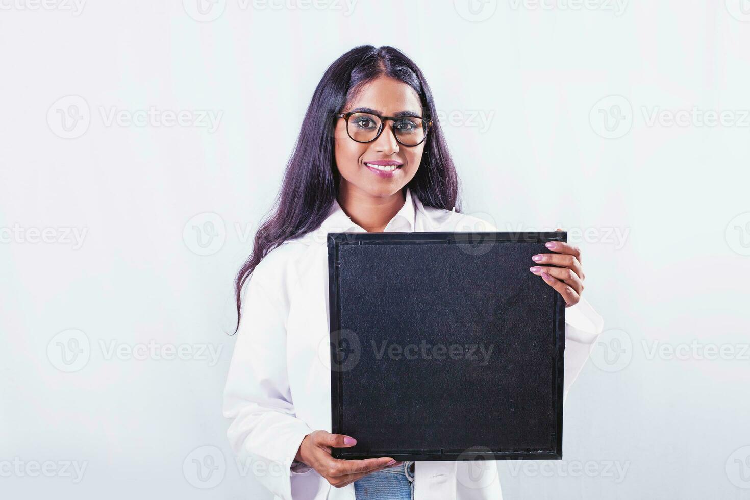 Young Indian female doctor  holding empty blank black signboard photo