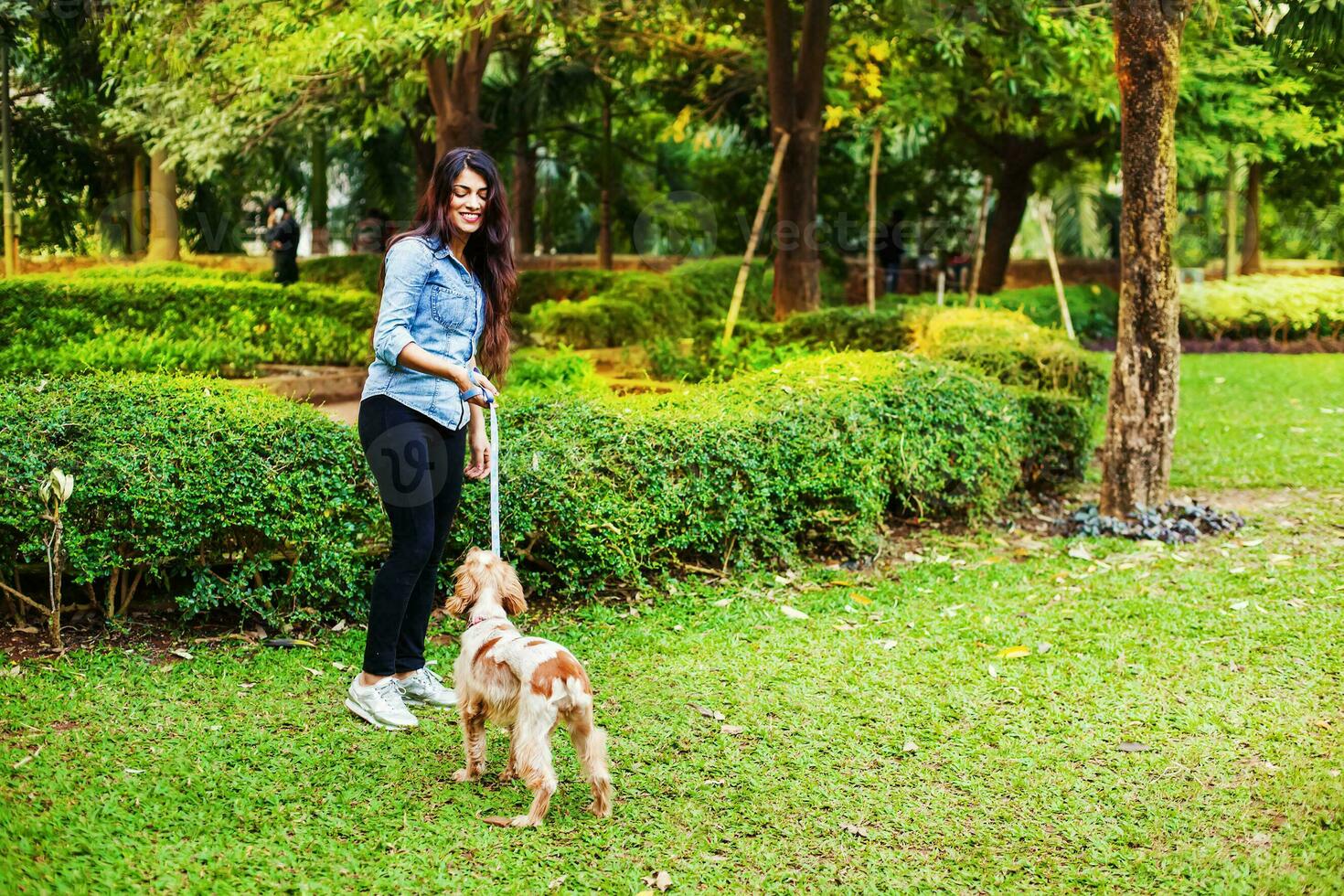 Beautiful Indian girl with her cocker spaniel dog photo