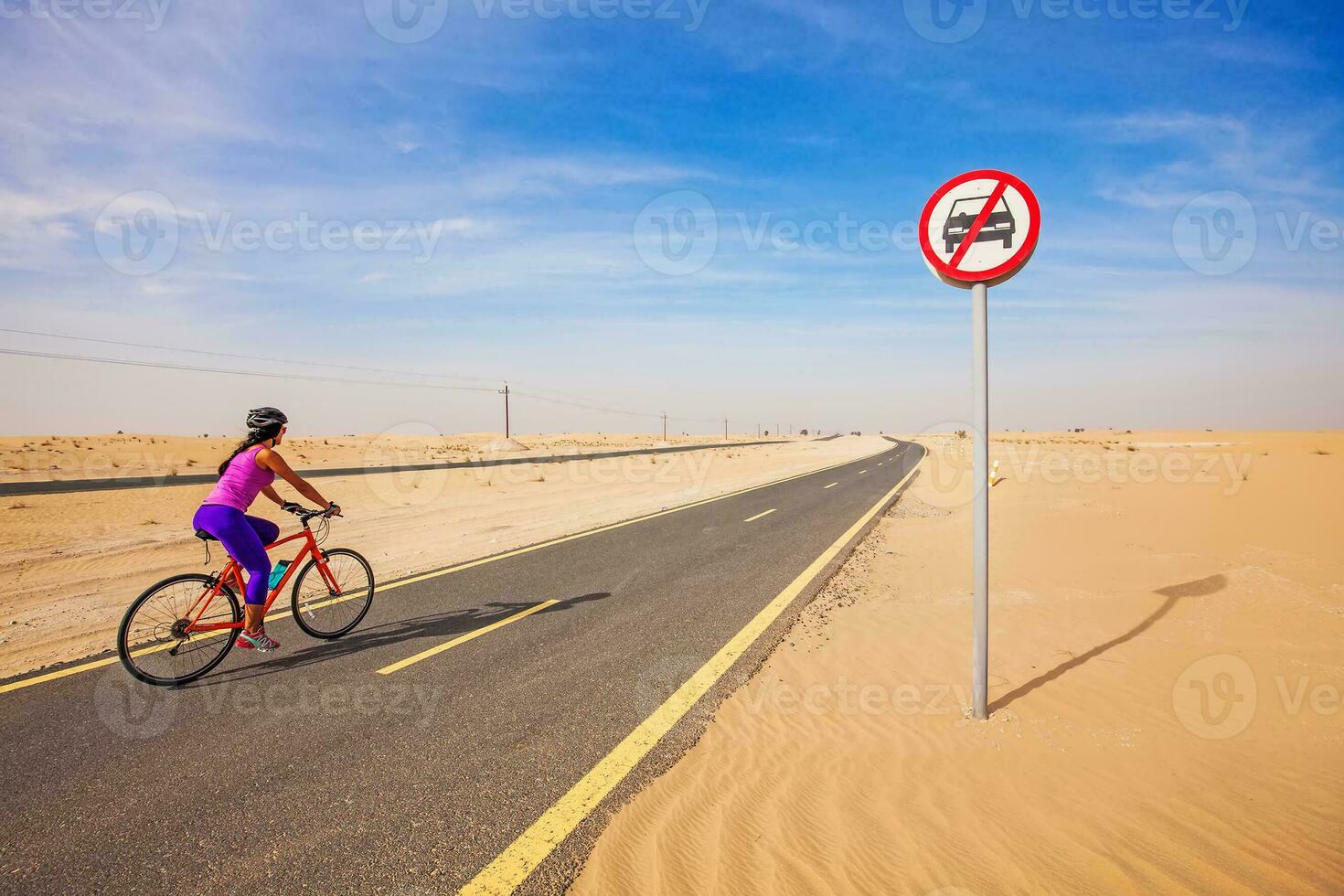 Young woman riding a bicicle photo