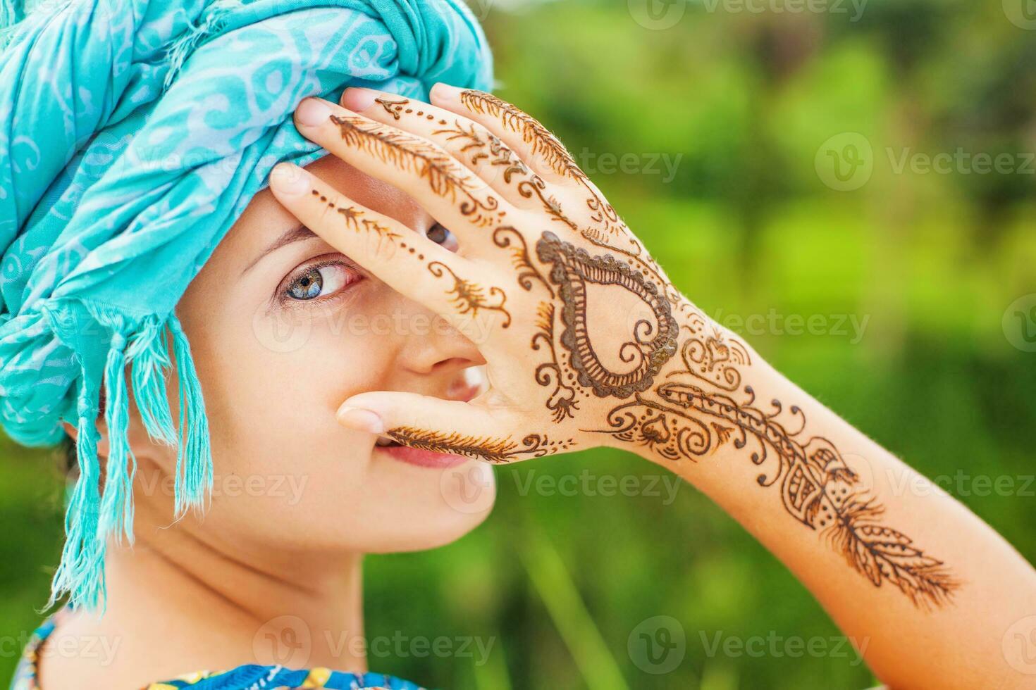 Woman with her hands painted with henna photo