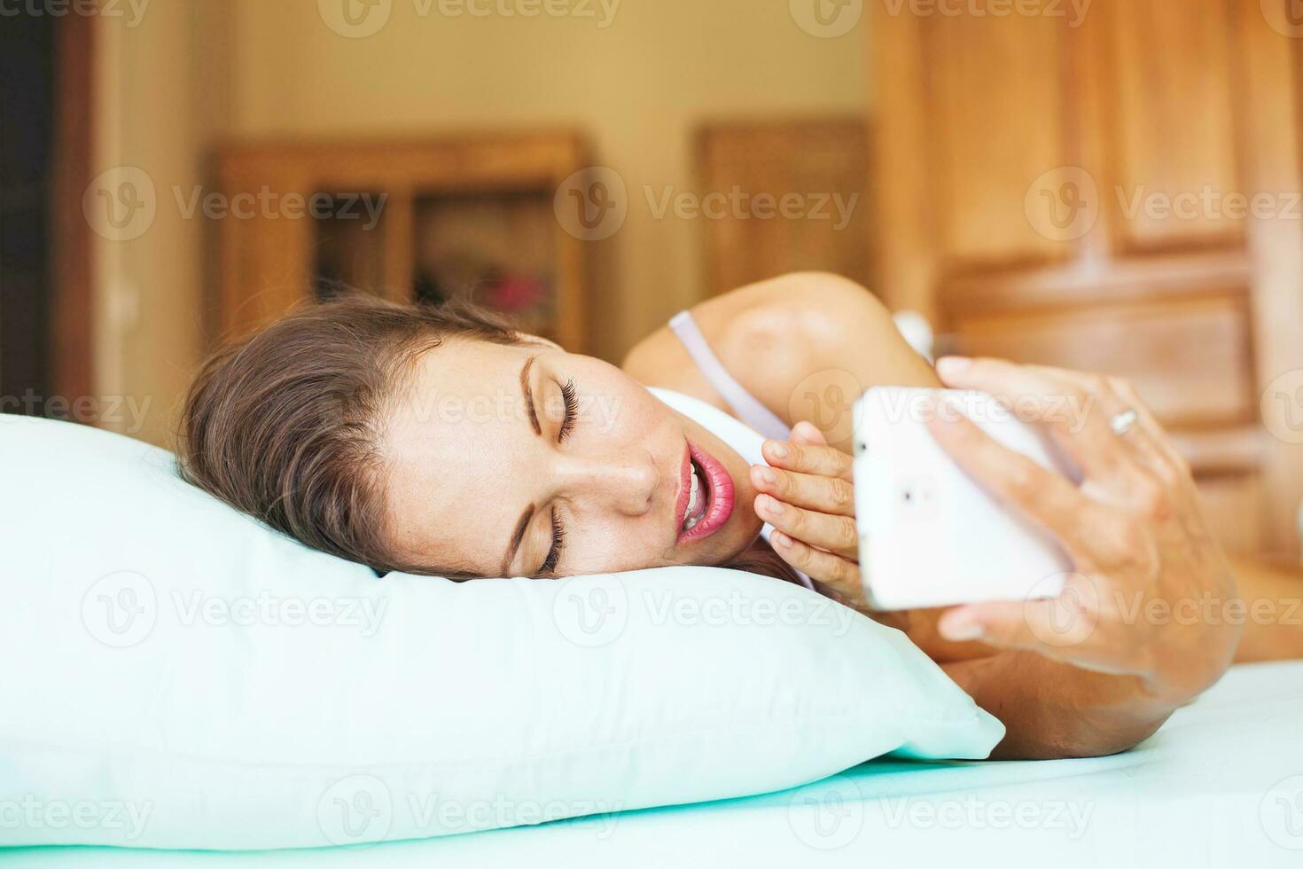 Woman using her phone as alarm clock 24754144 Stock Photo at Vecteezy