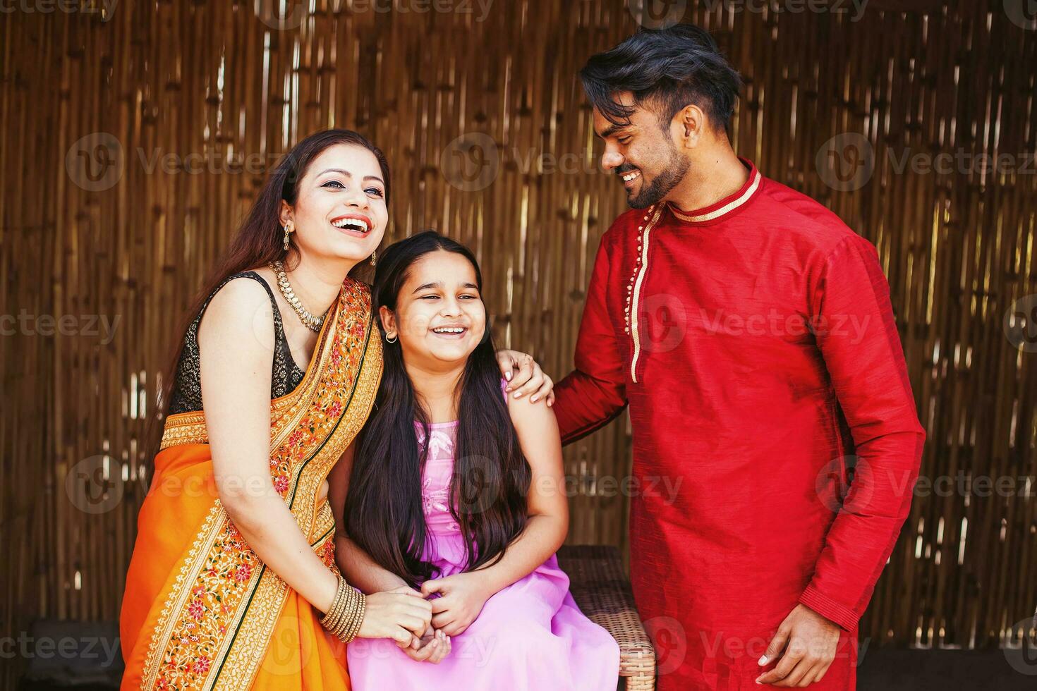 Beautiful Indian young family laughing, hugging, spending time together at home photo