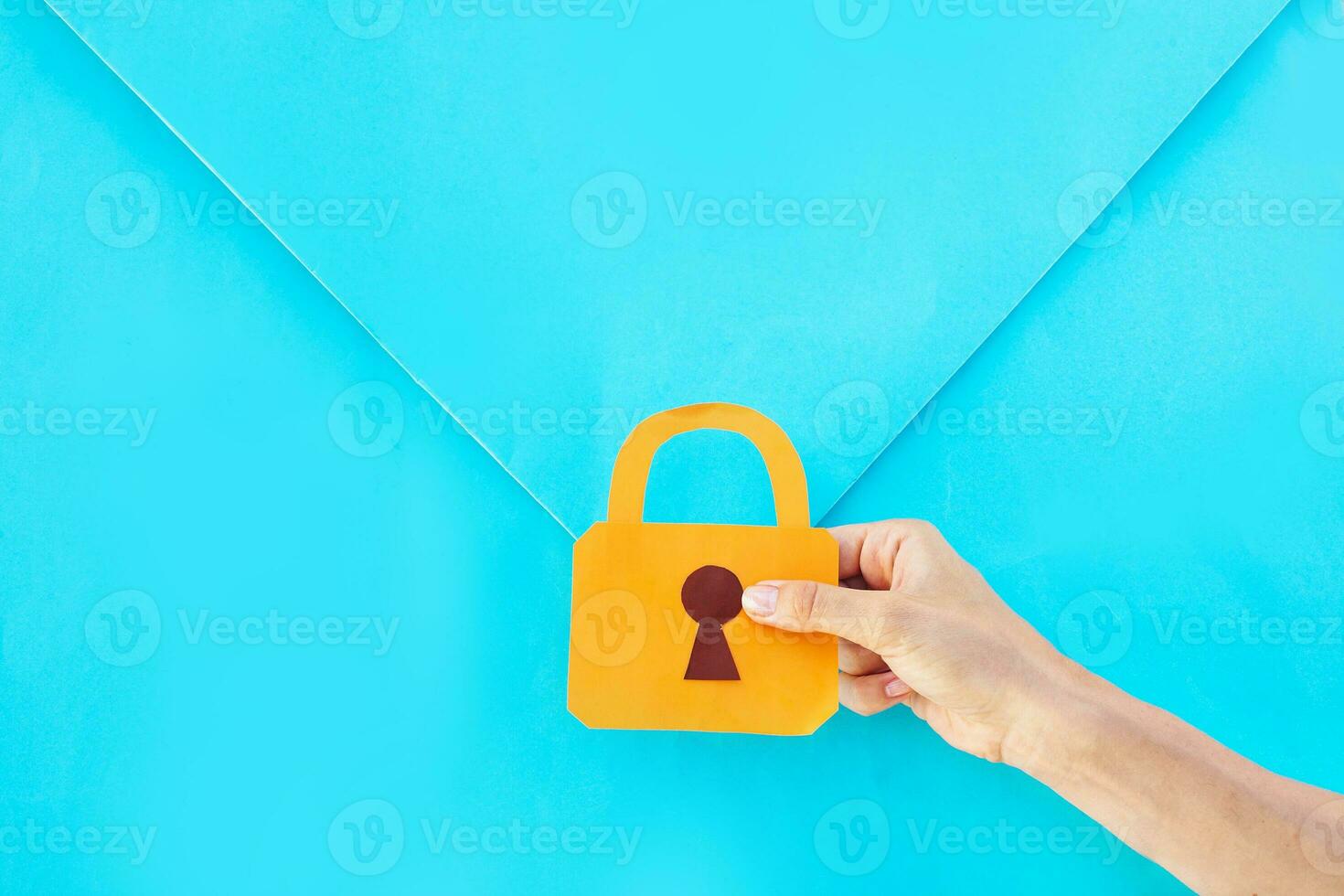 security of information concept. hand holding a lock over the envelope photo