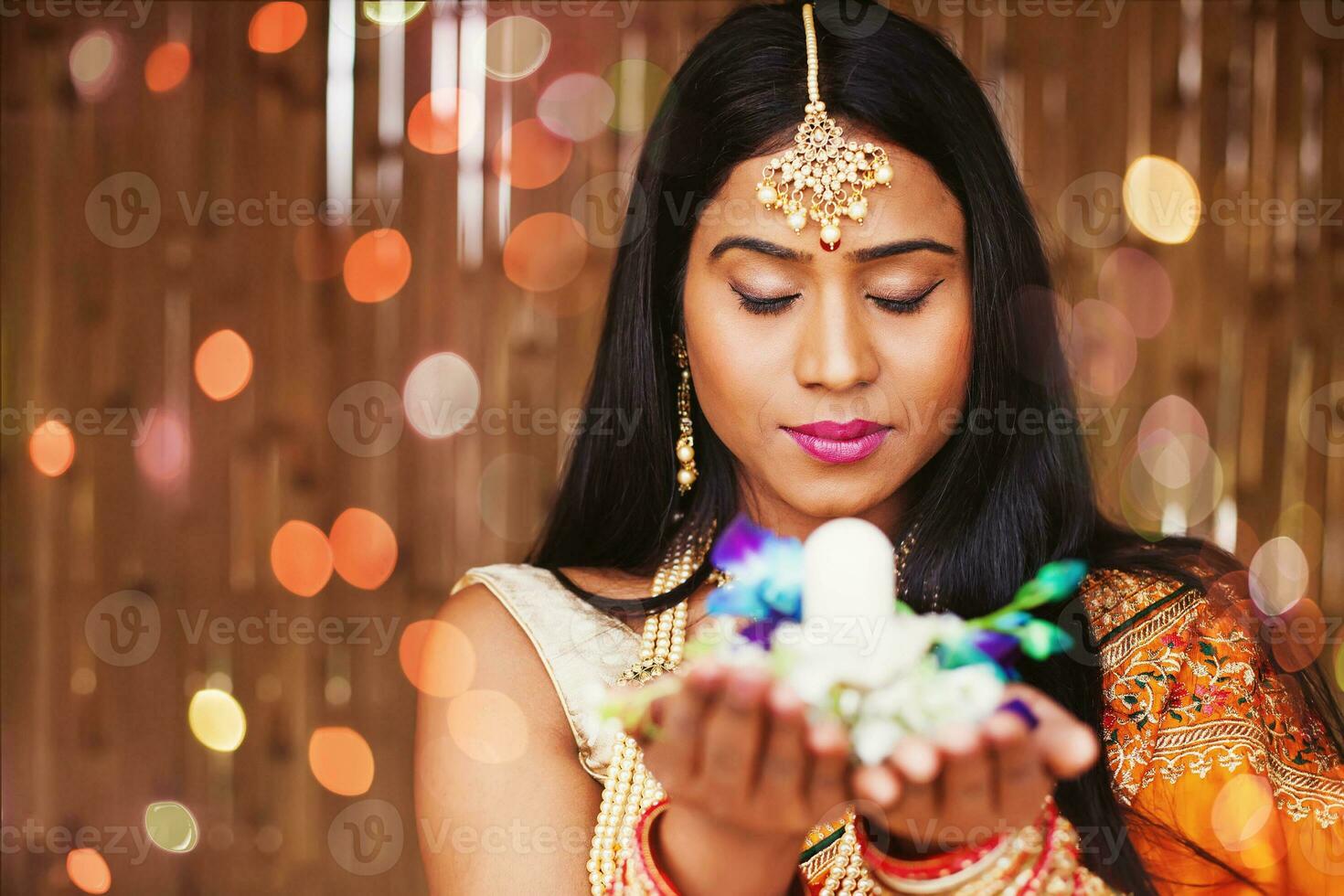 Beautiful Indian woman holding Shivling in her hands on Shivratri night and praying to God, meditating photo