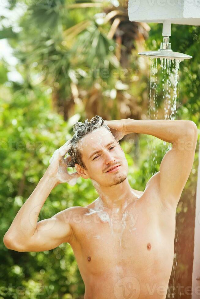 man enjoying washing outdoors photo