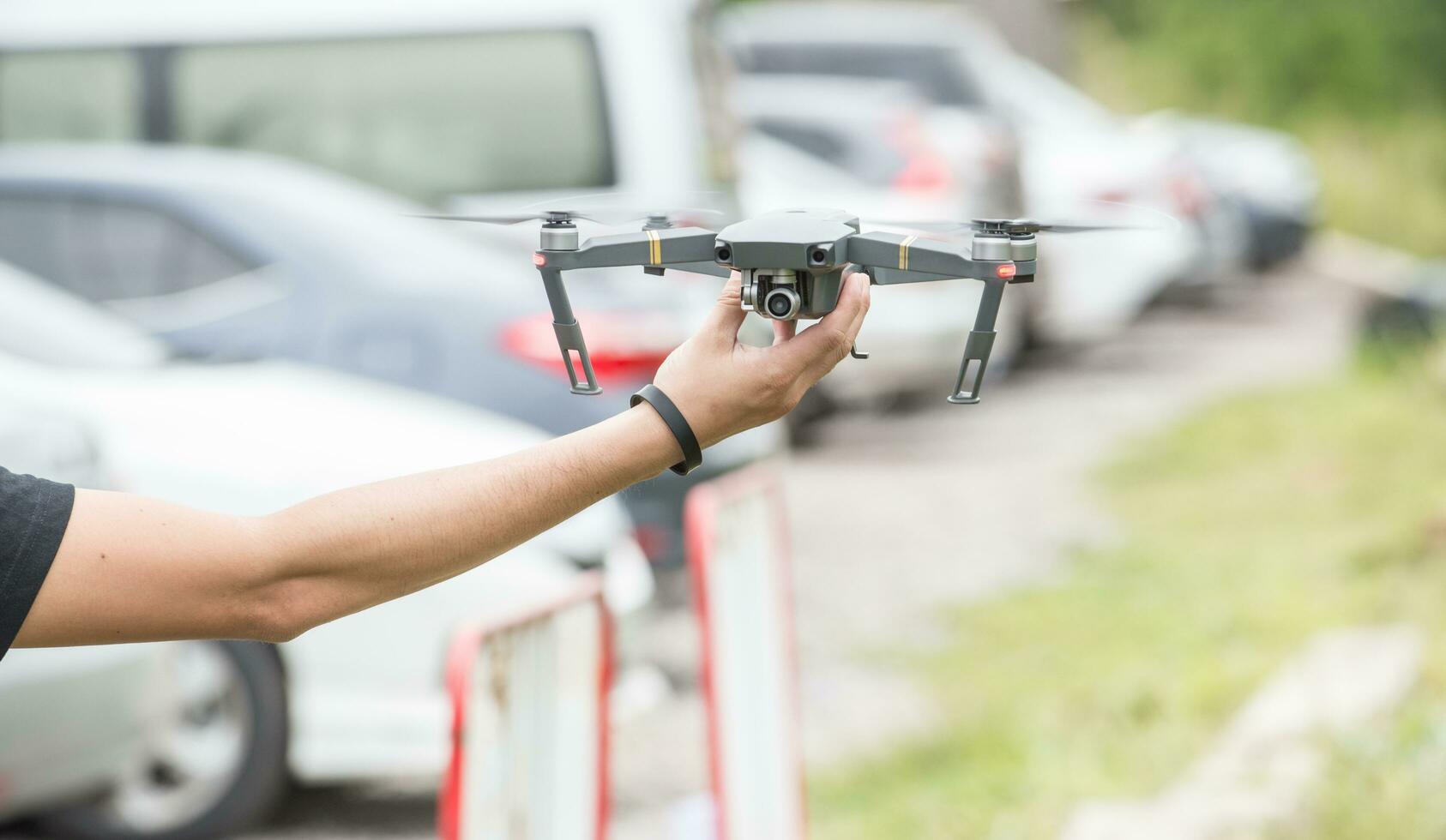 Cropped shot view of human holding a flying drone in his hand. photo