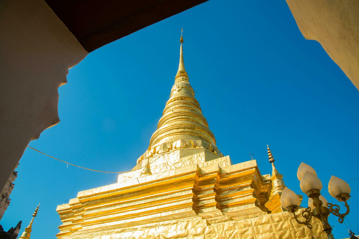 Wat Phra That Chae Haeng the iconic famous temple in Nan province in the Northern Thailand. The gilded chedi that contains a relic of the Buddha. photo