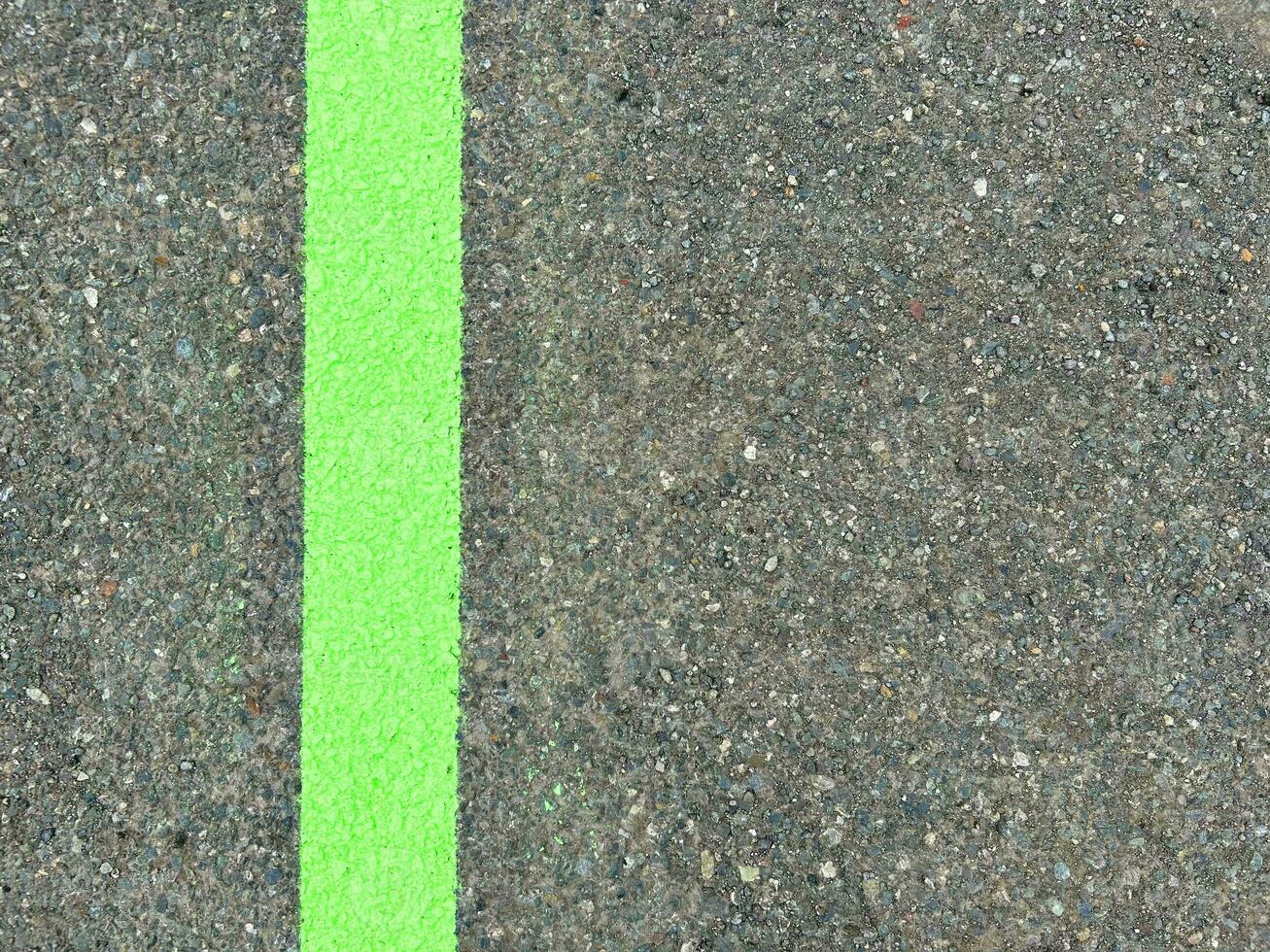 Green lines on asphalt, green paint on asphalt photo