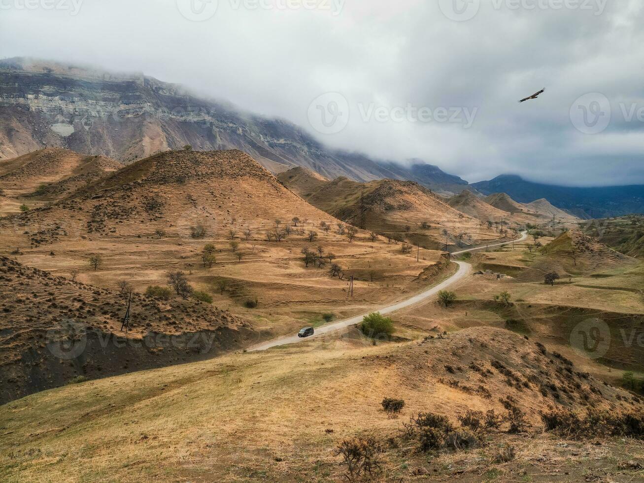 Scenic winding road in red valley. Dramatic view of winding road in high mountain pass. Dagestan. photo