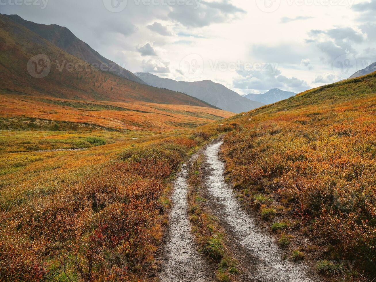 Wet off road through the rainy summer mountain plateau. Terrible thunderclouds have hung over the autumn valley. The sky before a thunderstorm with thunderclouds. photo