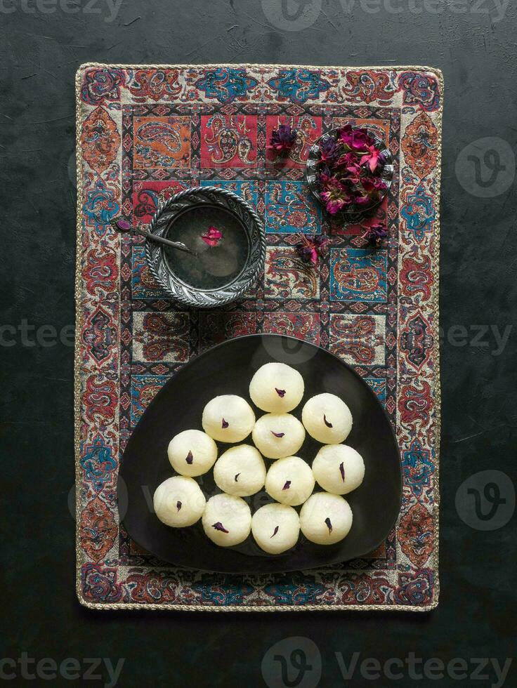 Indian traditional sweet rasgulla, close up, copy space photo