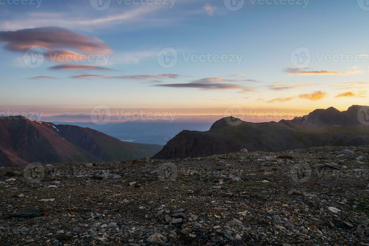 Dawn in the mountains. Colorful nature scenery with sunset or sunrise.  Atmospheric landscape with silhouettes of mountains with trees on background of orange dawn sky. photo