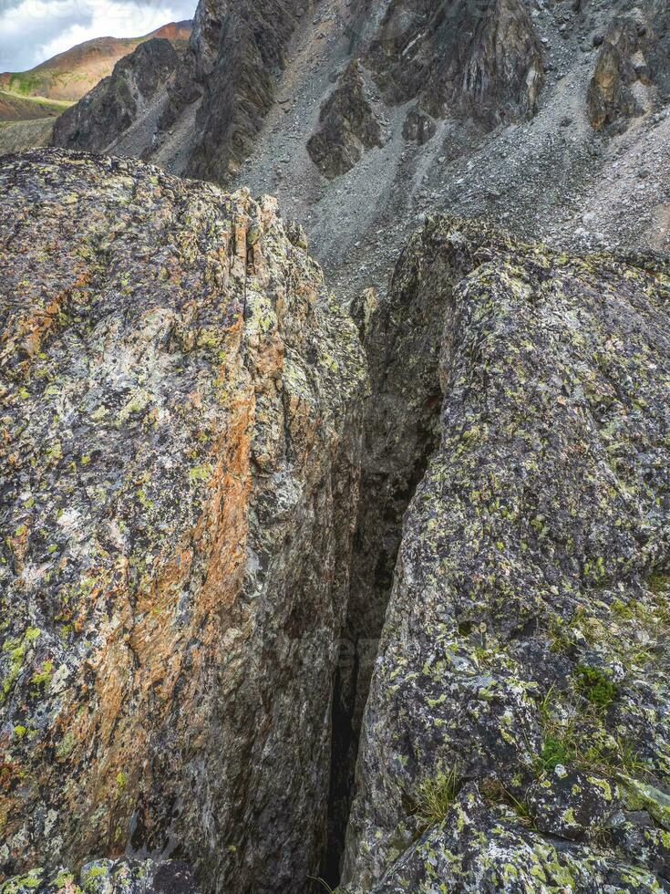 Dangerous fault in the granite rock. Fault line or fracture in the rock, erosion, a crack in the stone. photo