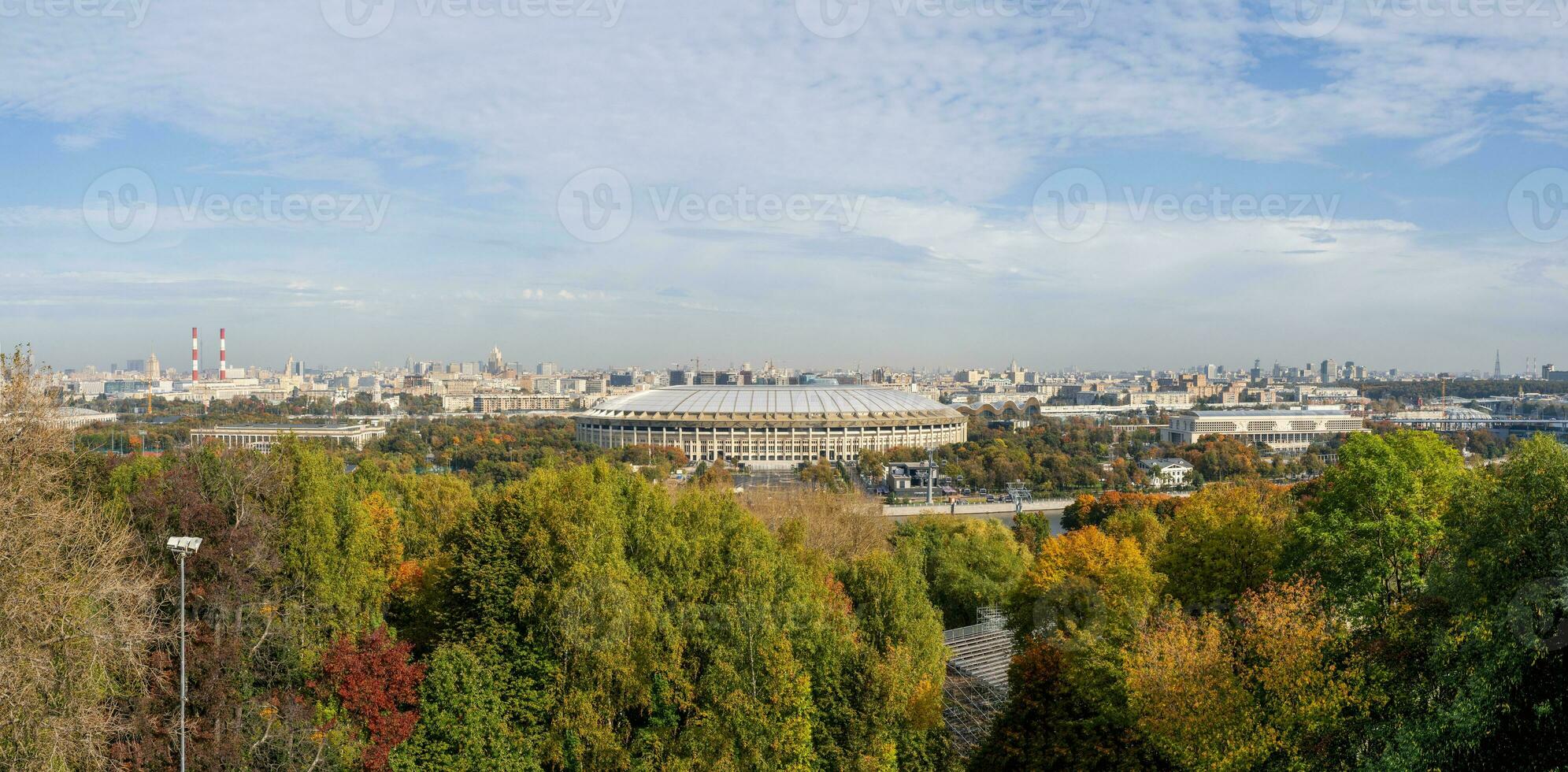 Autumn view of Luzhniki sports complex in Moscow. Wide panorama with a beautiful view of Moscow from the Sparrow hills. A famous tourist destination. photo