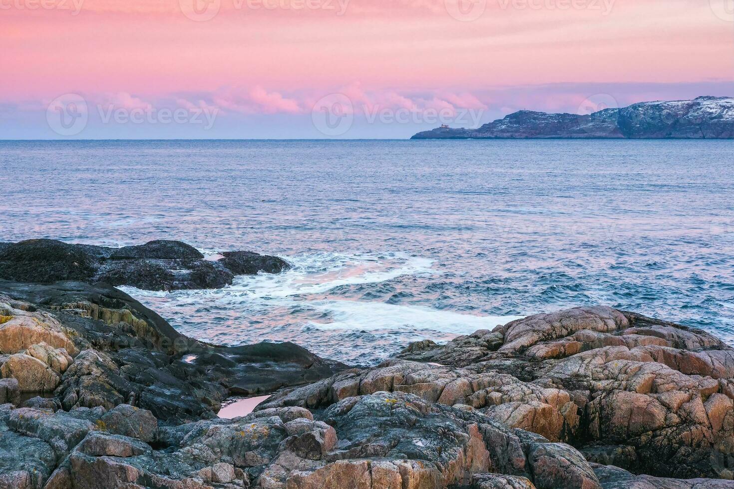 Northern sea sunset. Beautiful landscape of an amazing sunset sky over beach Barenzev Sea. Traveling to Northern Ocean. photo