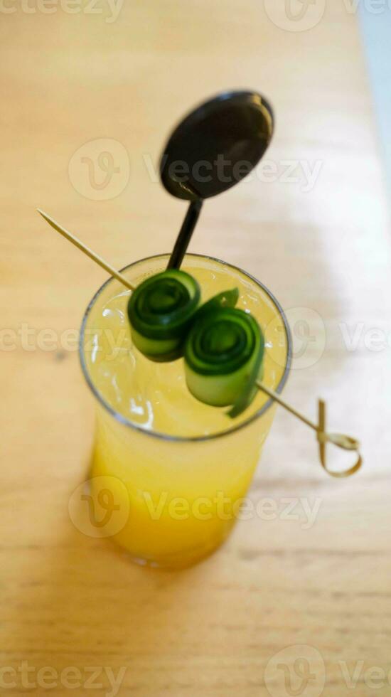 Tropical blush mocktail sweet and fresh drink with assorted tropical fruit mango and orange and soda. photo