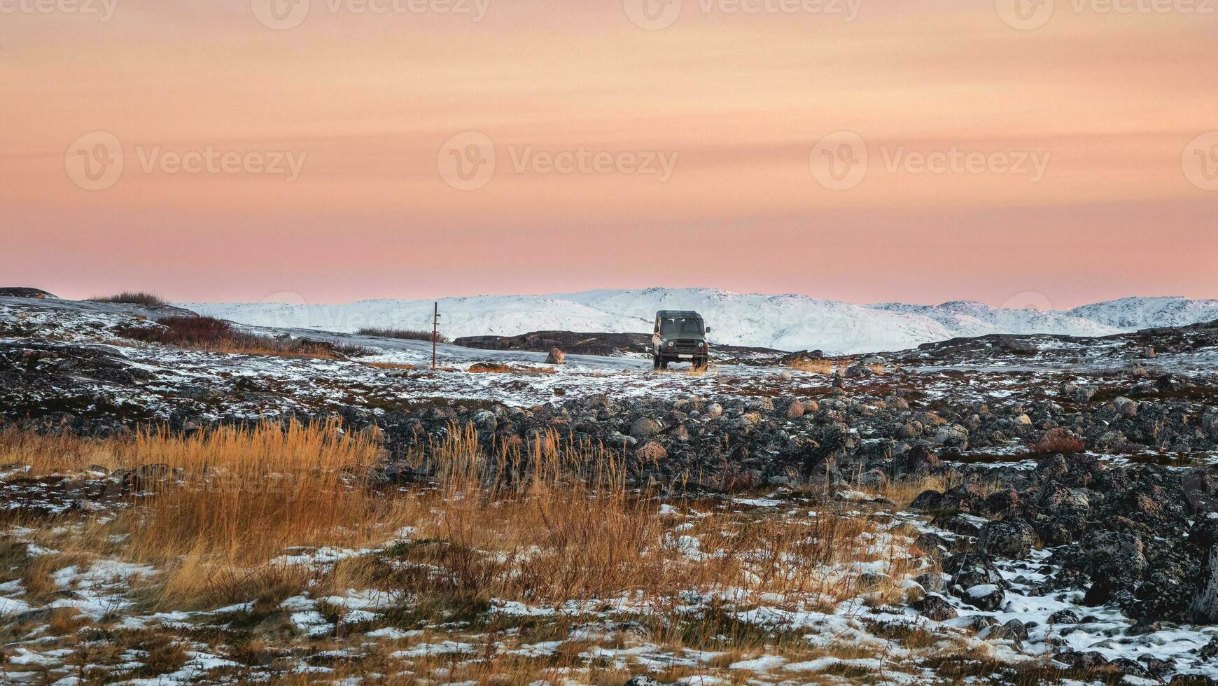 Panoramic view drop-off of tourists by car. Icy slippery Arctic road through the tundra. photo