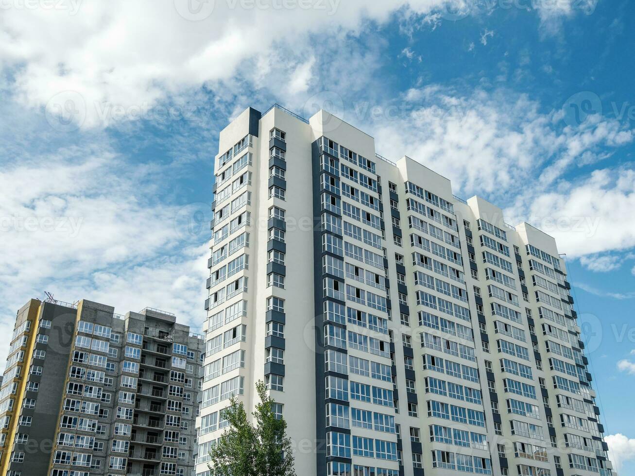 moderno construcción, nuevo vecindario. hermosa nuevo edificios de colores pared en el antecedentes de azul nublado cielo. Copiar espacio. foto
