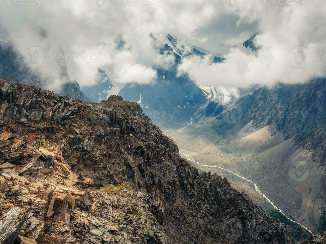 Amazing spring landscape with silhouettes of big rocky mountains and epic deep gorge with river.The edge of a rocky cliff with a beautiful view of the gorge. photo