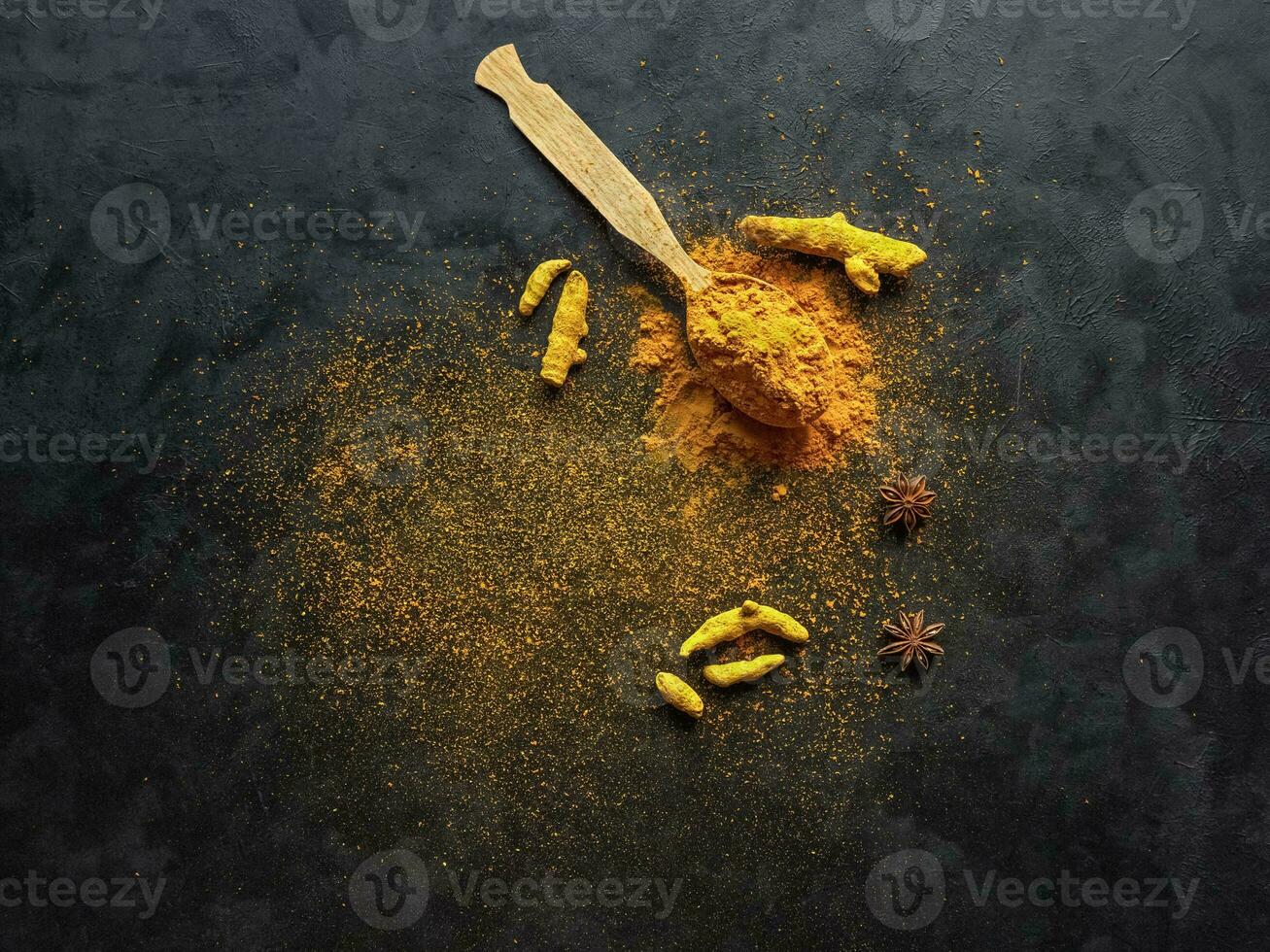 Turmeric powder and roots turmeric on black background photo