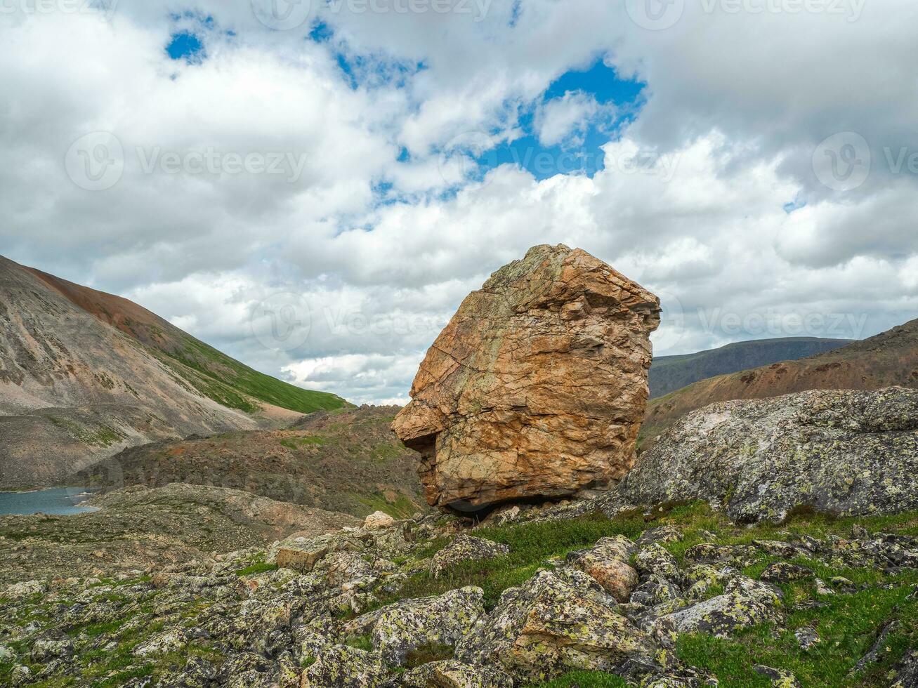 Beautiful mountain landscape with big granite stone among on hill and mountains. Colorful highland scenery with big rock among green vegetation and mountains. photo