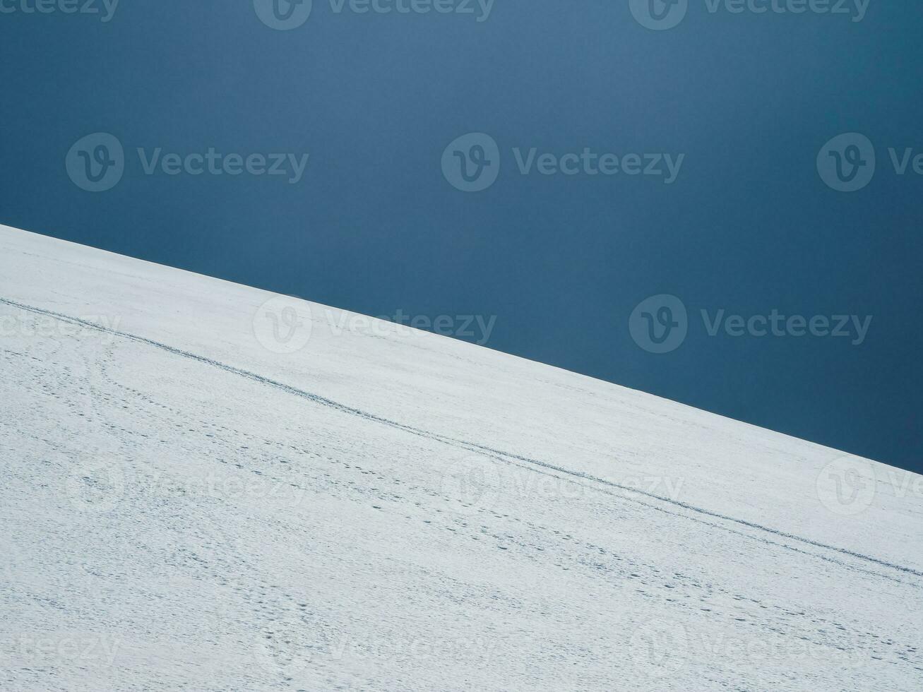 Ski slope. Snow mountain and dark blue sky. Beautiful minimalistic landscape of white snow hill. photo