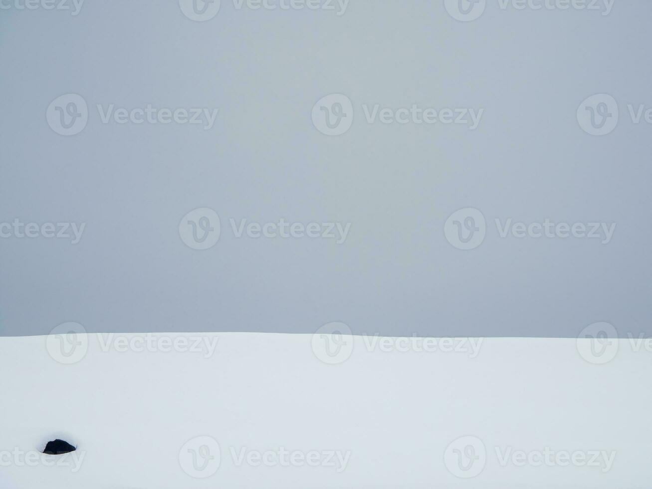 Gray gradient, snowdrift on a gray sky background. Snowy surface, abstract background. photo