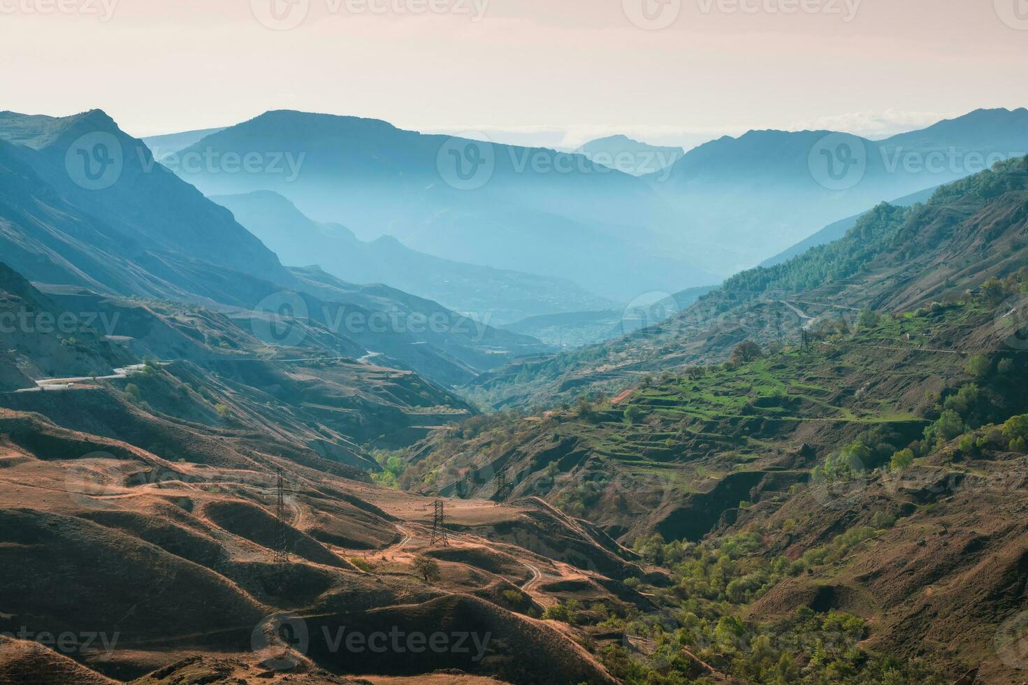 Scenic dawn mountain landscape. Mountain texture, mountain terrain. Vivid sunset or sunrise scenery with low clouds in mountain valley in soft color. photo