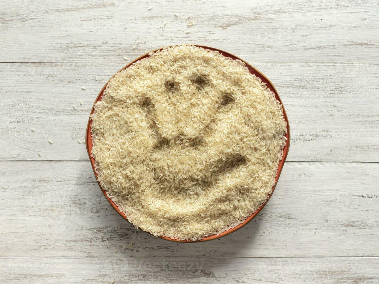 A handprint in a plate of raw rice. photo