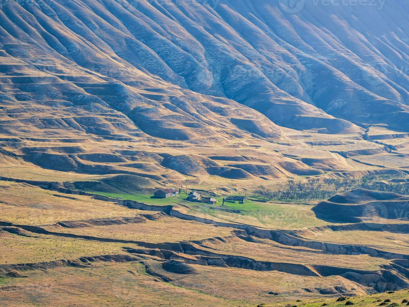 Texture of wavy mountain slopes. Mountain texture, mountain terrain. Dagestani hills from above. photo