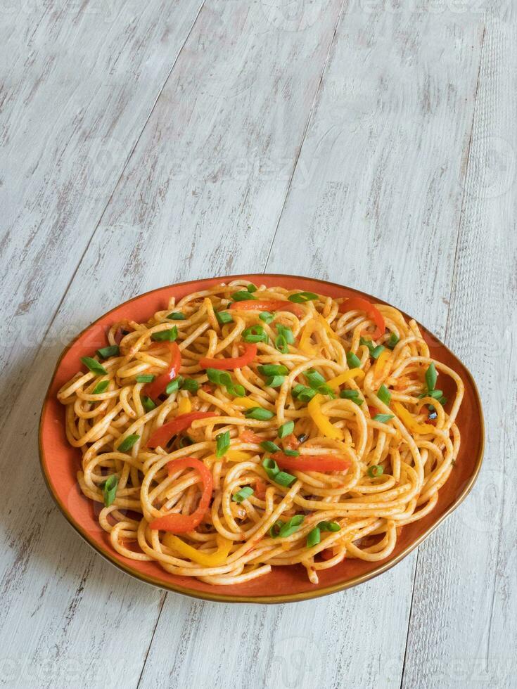 Spaghetti with vegetables on a plate photo