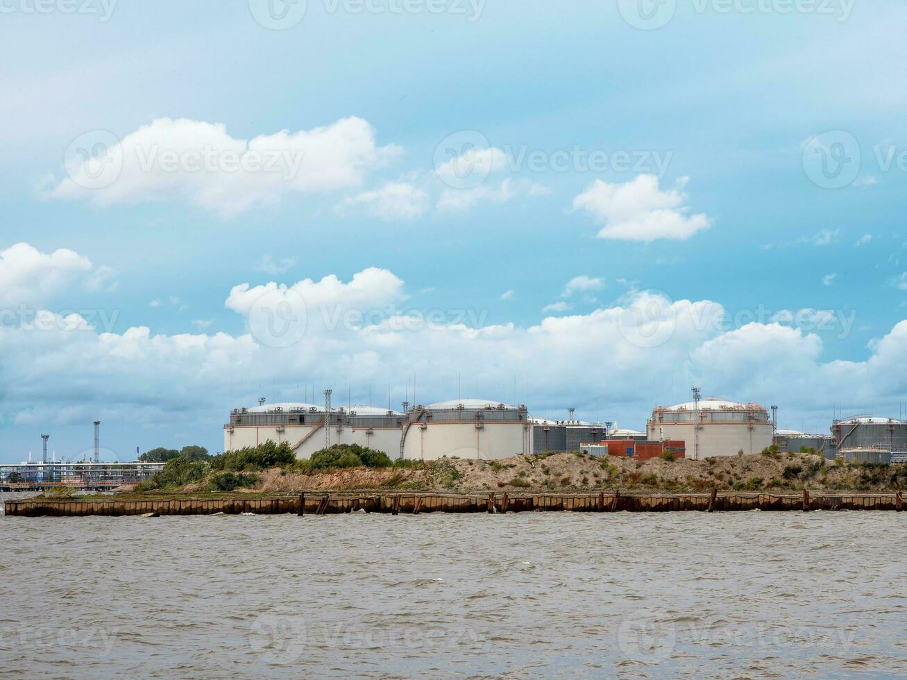 Large cisterns on the island. Tank farm oil and gas terminal in Saint Petersburg, Business power and energy industrial tank storage photo