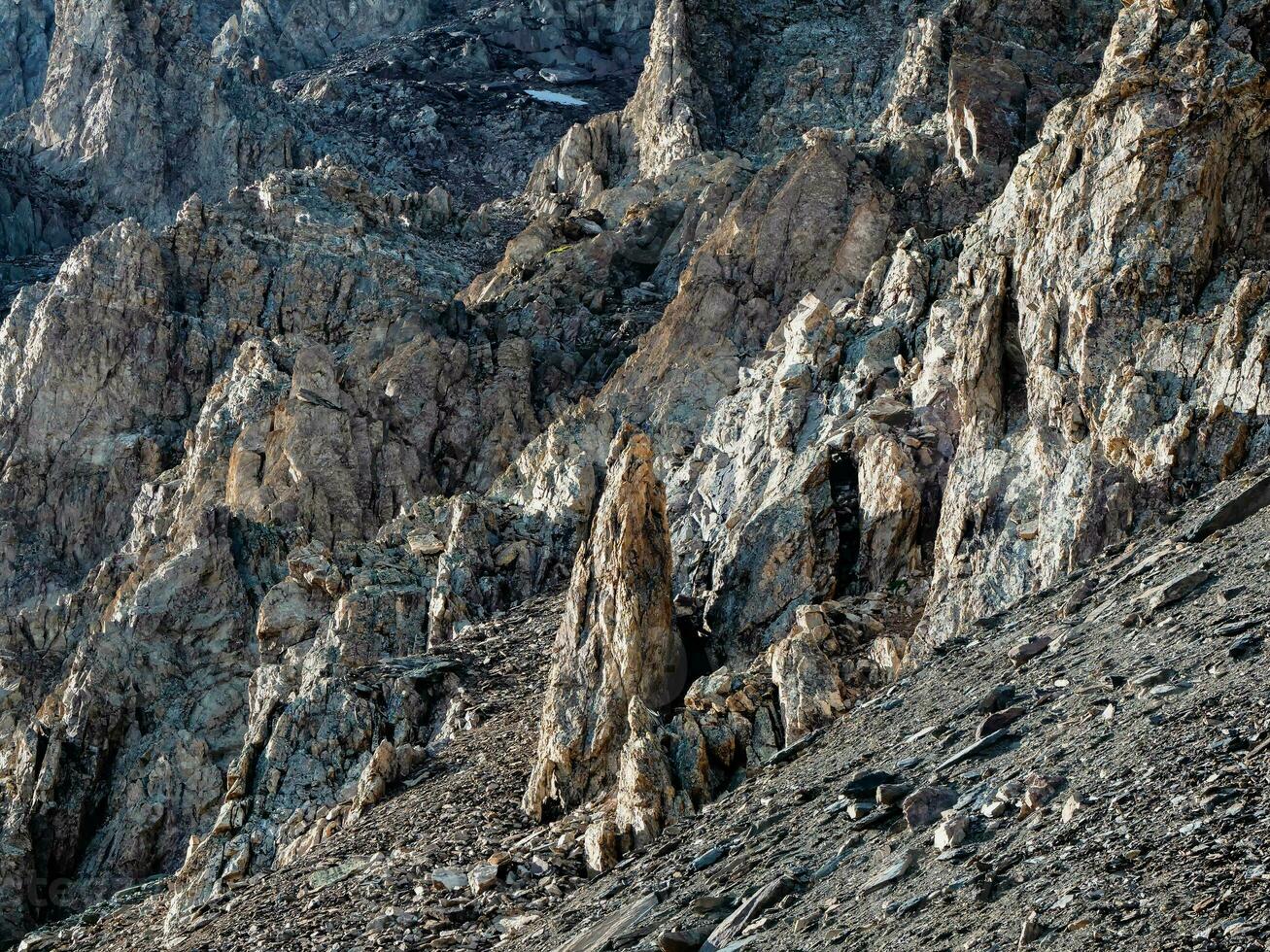 Awesome scenic mountain landscape with big cracked pointed stones closeup in sunlight. Sharp rocks background. photo