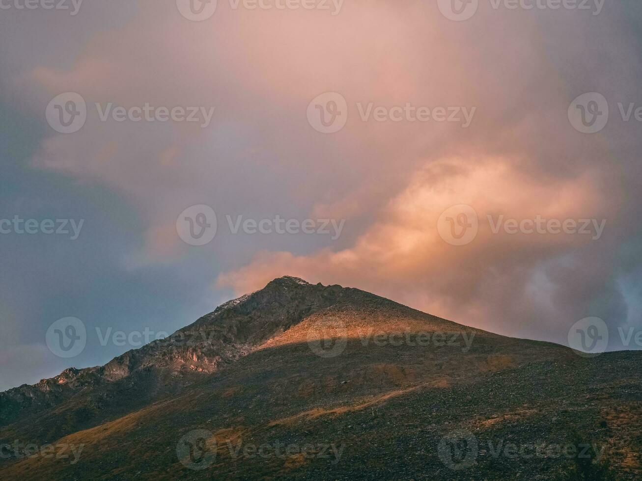 Mountains at dawn. Atmospheric landscape with silhouettes of mountains on background of pink dawn sky. Colorful nature scenery with sunset or sunrise. Sundown in faded tones. photo