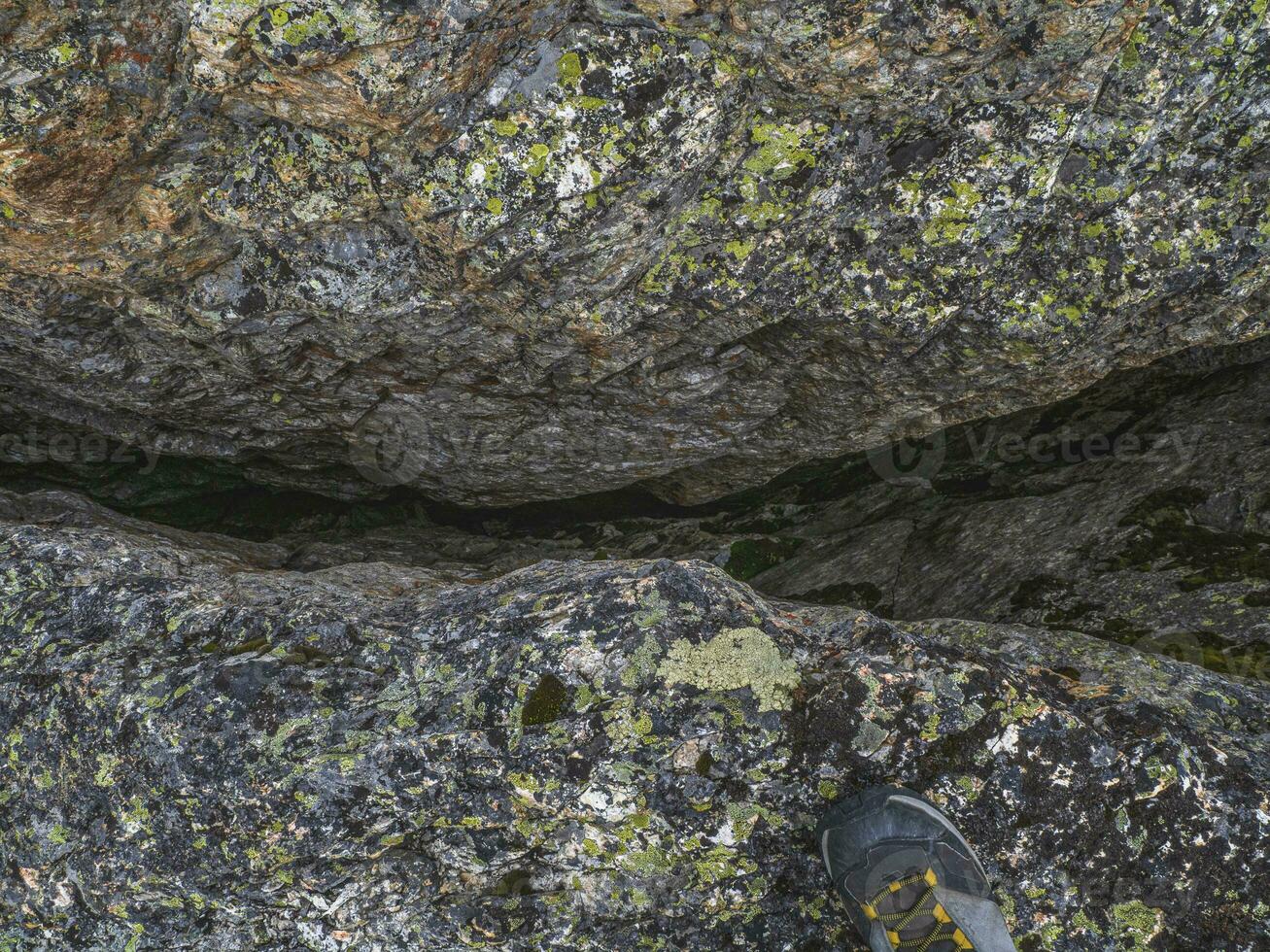 Dangerous fault in the granite rock. Fault line or fracture in the rock, erosion, a crack in the stone. photo