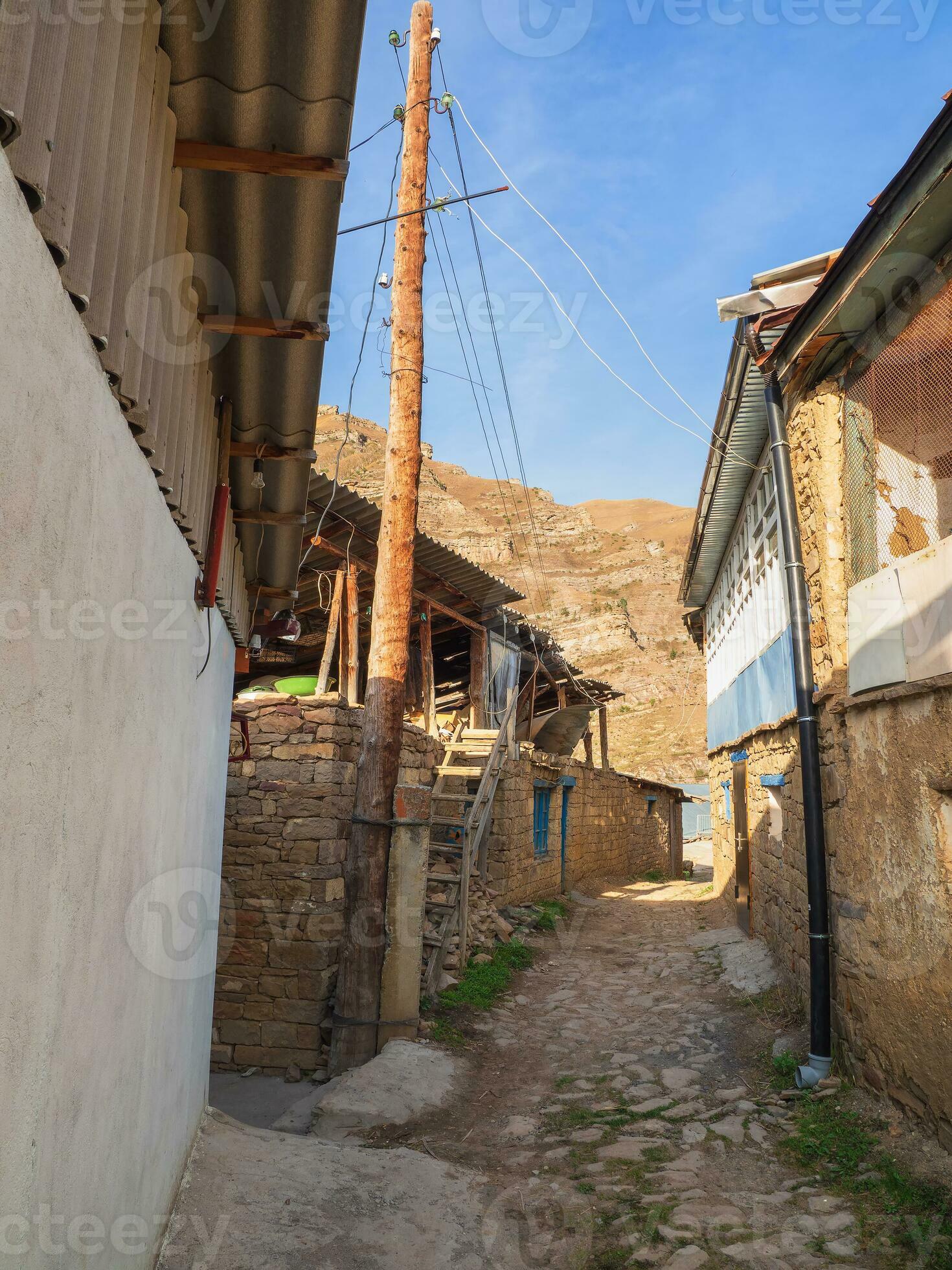 Narrow alleys of a mountain village. Rural clay and stone houses in a