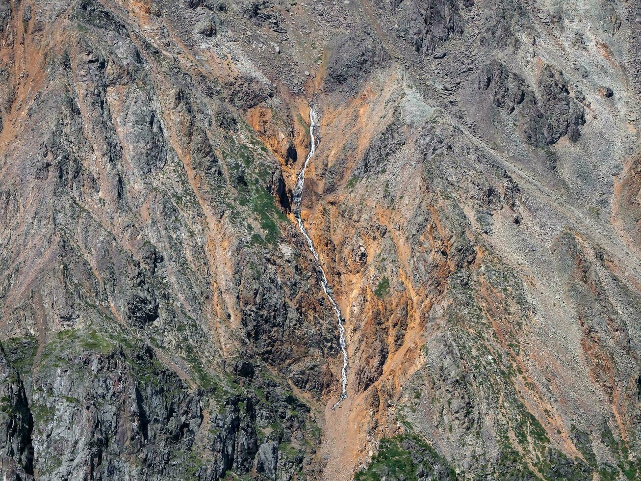 Texture of mountains. Aerial view of mountain gorge with a curved river line. photo