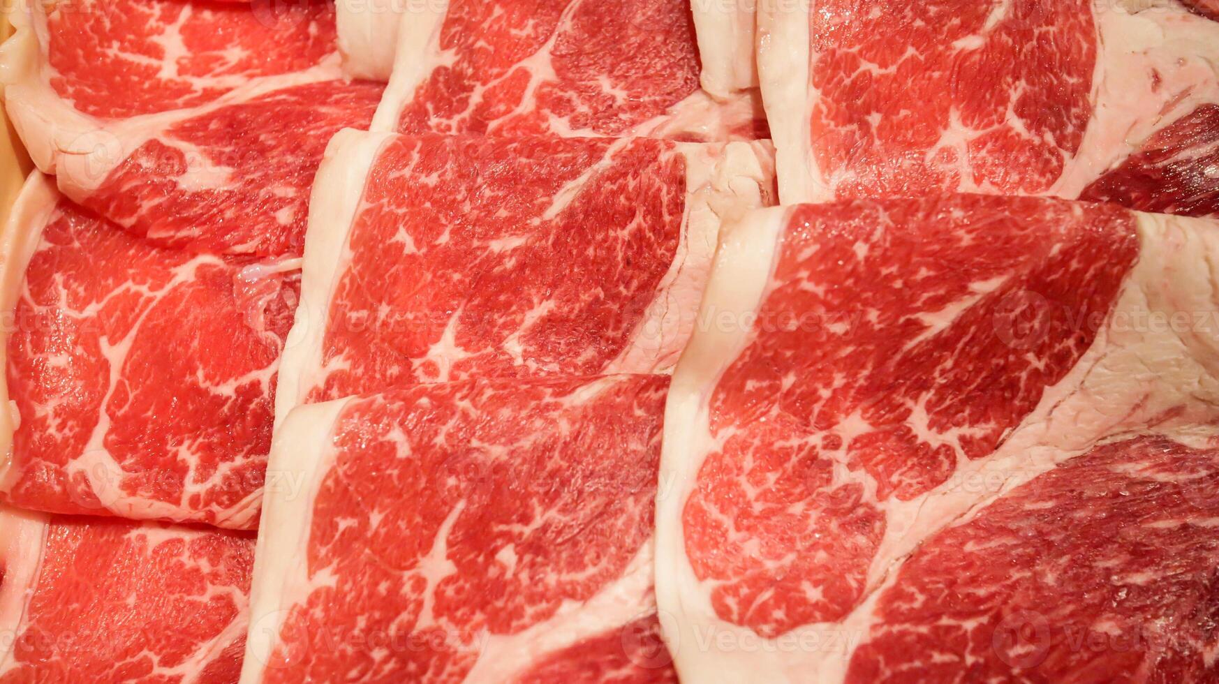 Fresh raw beef slices meat for Japanese food shabu shabu or yakiniku barbeque. Slice of high quality wagyu meat. photo