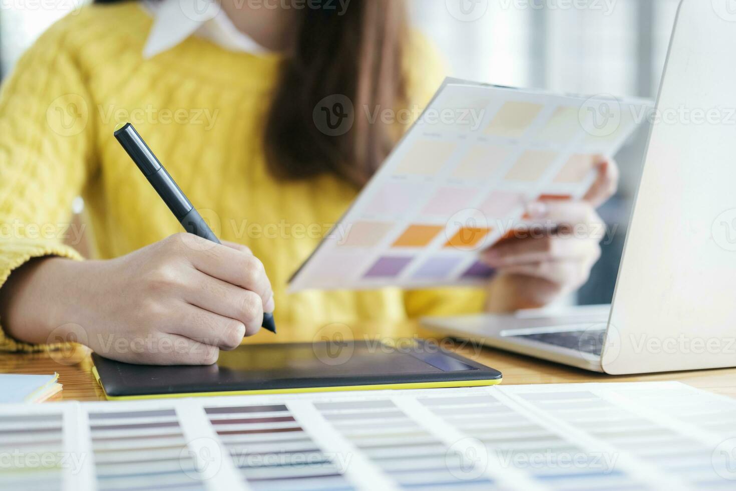 Young photographer and graphic designer at work in office. photo
