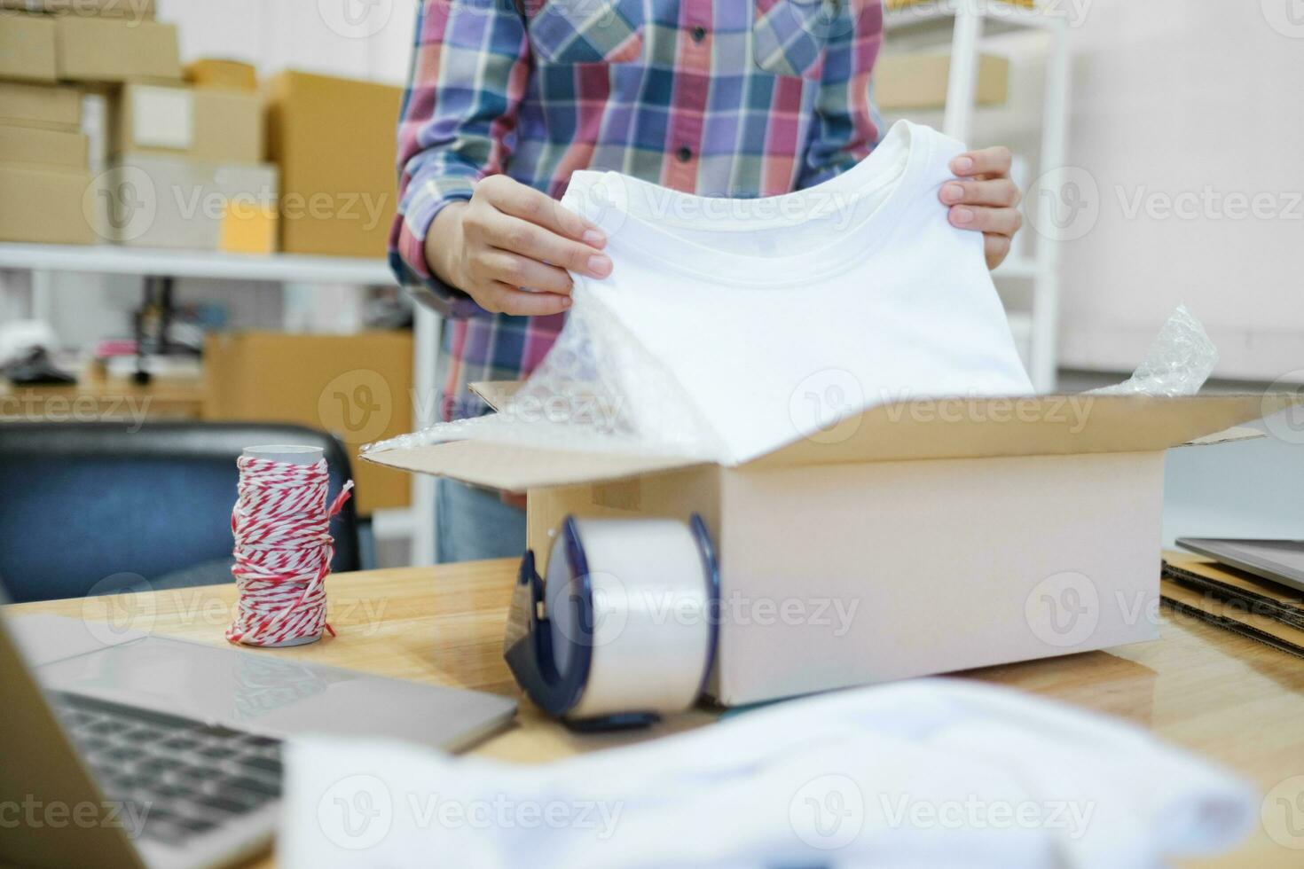 Online business owner preparing product to customer. photo